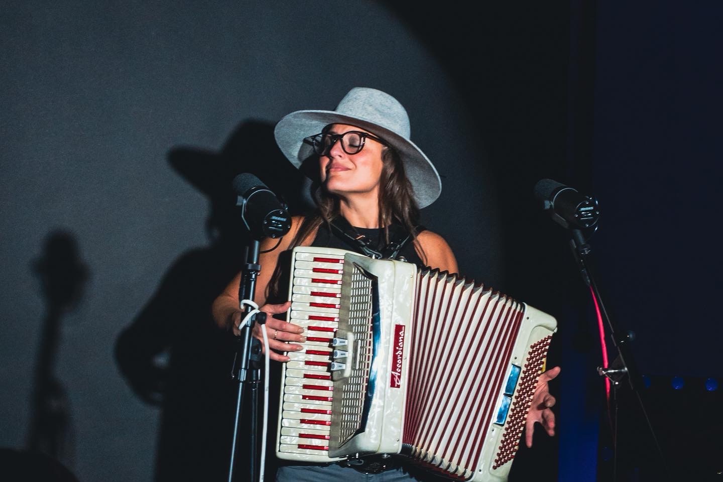 Christina performing with an accordion on stage